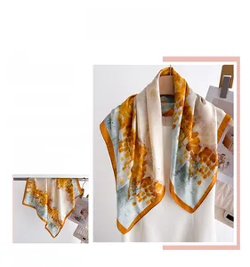 Detailed view of ginger yellow and blue abstract print silk scarf with fine edge stitching