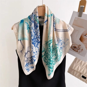 Detailed close-up of blue ink floral patterns on a premium silk scarf for women