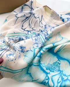 Detailed view of ink floral print on premium silk scarf with smooth draped texture