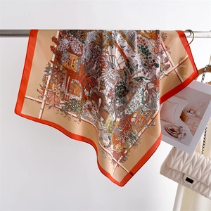 Detail of vintage floral silk scarf with tropical bird prints and orange border edge