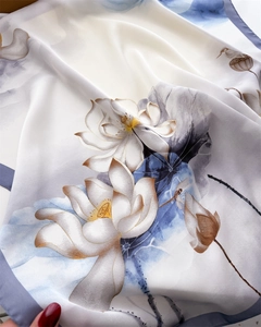 Detailed texture of silk scarf with Chinese ink lotus pattern and refined blue hem