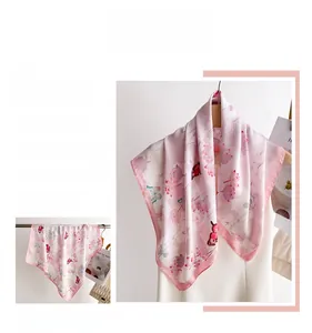 Detailed close-up of butterfly and lotus print pattern on an elegant silk scarf for women