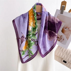 Elegant purple silk scarf with ink lotus floral print and bird hanging on a hanger