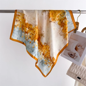 Detail of artistic abstract print silk scarf with ginger and blue patterns