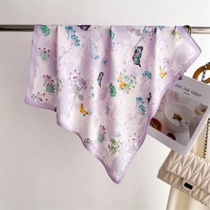 Detail of silk square scarf featuring elegant butterfly and lotus prints in lavender purple