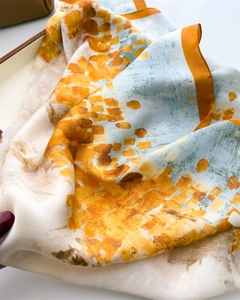 Artistic abstract print silk scarf with refined orange hand-rolled edges and smooth texture