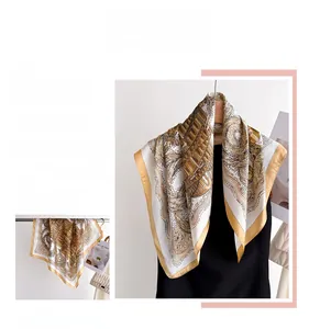 Detail of elegant architecture print silk scarf with luxury champagne gold border