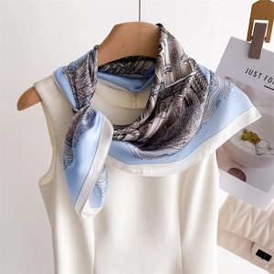 Detailed texture of silk scarf with classical architectural prints on a wooden hanger