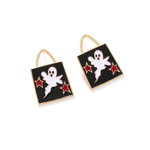 Halloween ghost earrings with red stars and gold hooks on black enamel background