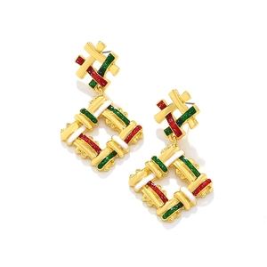 Detail of woven texture gold earrings with festive red, green, and white enamel drippings