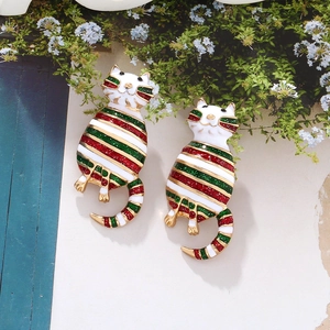 Detail shot of cute cat-shaped Christmas earrings with colorful glitter enamel and gold metal