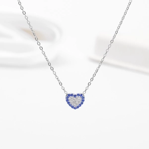 Silver titanium necklace with heart pendant featuring blue and white zircon crystals