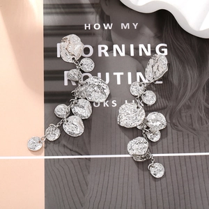 Long vintage silver-toned earrings with hammered metal discs and fringe drop design