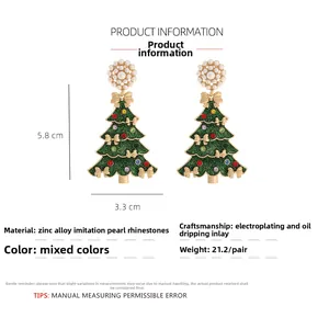 Detail view of 5.8cm Christmas tree earrings with pearls, rhinestones and green enamel
