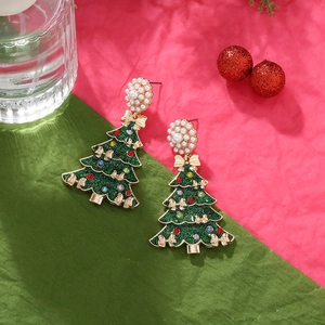 Christmas tree earrings with colorful rhinestones, pearls, and a bow on a festive background
