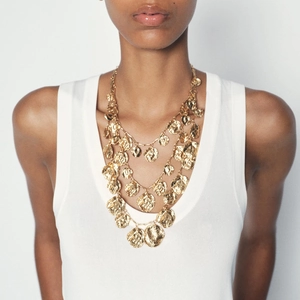 Elegant multi-layer gold necklace featuring textured irregular round metal pendants