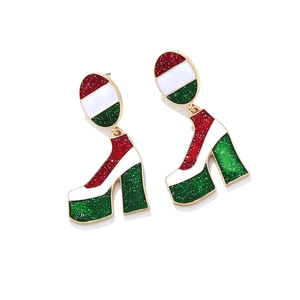 Close-up of red, white, and green enamel high heel boot earrings with gold plated frames