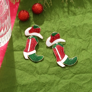 Christmas themed earrings featuring red and green glittery cowboy boot and hat designs