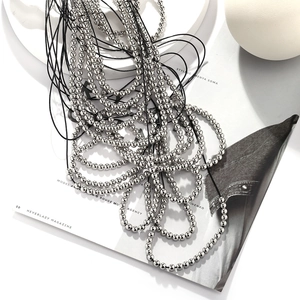 Multilayer silver beaded waterfall necklace with black cords for a stylish layered look