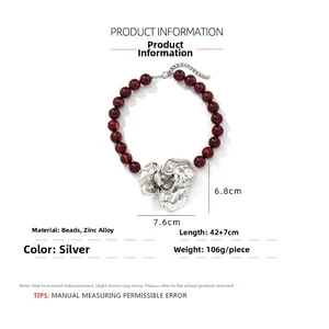 Detailed view of silver flower pendant with red resin beads and dimension specs