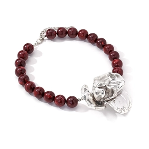 Detail of beaded necklace with dark red marble beads and large silver flower pendant
