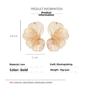 Detailed view of large golden hollow flower earrings with multi-layered petal design