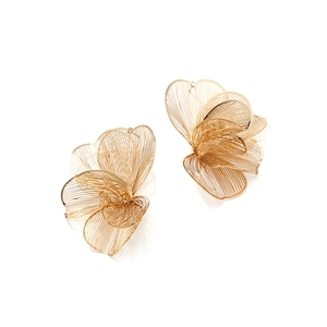 Macro detail of gold flower earrings showing intricate layered metal wire petals