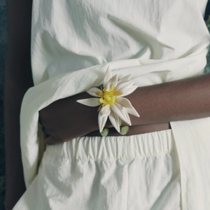 Close-up of bohemian white beaded flower bracelet on wrist for vacation styling