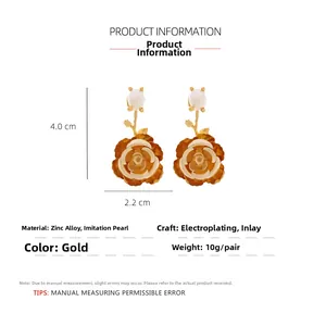 Detail view of gold camellia flower earrings showing dimensions 4.0cm x 2.2cm and pearl inlay