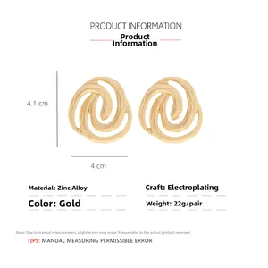 Detail view of gold spiral earrings with dimensions 4.1cm by 4cm and hammered texture