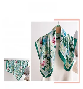 Detail of elegant floral silk scarf with satin finish and vibrant botanical print