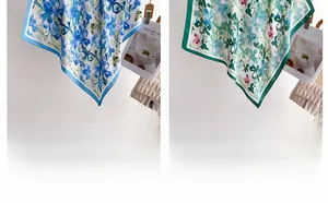 Detail view of elegant floral silk scarves in blue and green with watercolor flower patterns