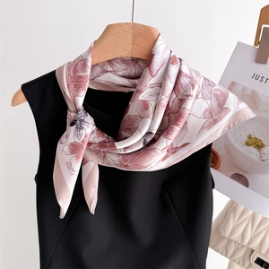 Elegant floral print silk scarf in lotus pink tied on hanger with stylish chain bag