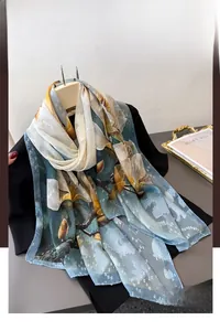 Detail of a sheer lightweight floral scarf with elegant blue and yellow patterns