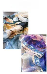 Detailed view of floral silk scarves featuring elegant magnolia and orchid patterns on chiffon