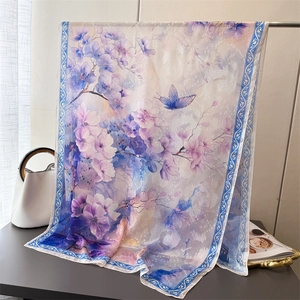 Detail of floral printed silk scarf with blue butterfly and elegant purple gradients