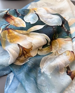 Detail of silk scarf showing white magnolia print and subtle jacquard texture