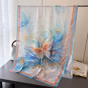 Detail of silk scarf with artistic butterfly prints and intricate red border patterns