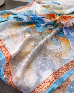 Close-up of floral print silk scarf with textured jacquard and rolled hem detail