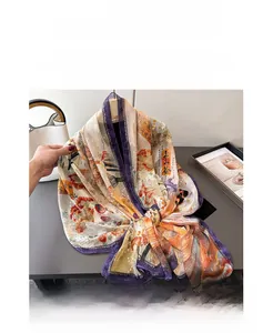 Detail showing semi-transparent silk scarf with orange floral prints and retro calligraphy