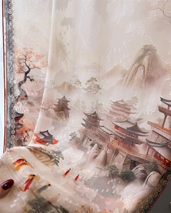 Detailed macro view of high-quality silk scarf with traditional Chinese landscape jacquard