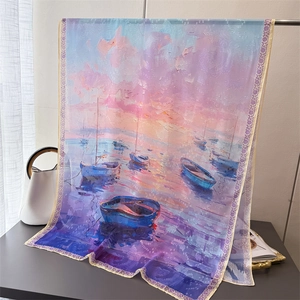 Detailed view of long lightweight silk scarf with sunset oil painting print and floral edges