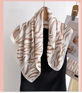 Close-up of zebra print silk scarf draped on hanger with elegant soft texture