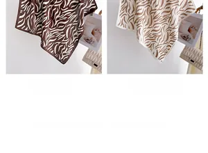 Detail of coffee and khaki zebra print silk scarves with neat stitching and smooth texture