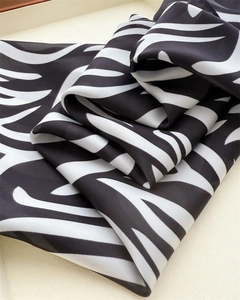 Close-up of zebra pattern silk scarf showing smooth texture and draped fabric finish