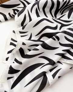 Close-up of zebra print silk scarf showing lightweight chiffon texture and neat edges
