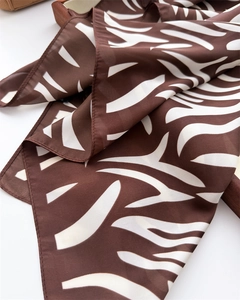 Close-up of zebra pattern silk scarf with smooth texture and rich brown white folds