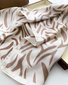 Detail shot of zebra print silk scarf with satin finish and fine machine stitching