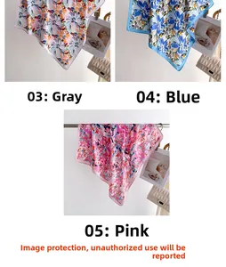Detailed close-up of grey blue and pink floral silk scarves hanging on metal racks