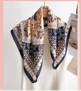 Detail of elegant paisley print silk scarf draped on a mannequin with baroque patterns
